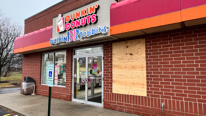 Dunkin' Donuts with a broken window after an overnight storefront burglary, Wednesday, December 14, 2022