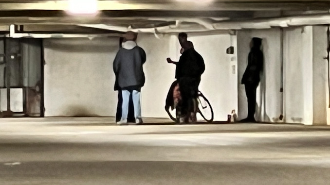 Several other people seeking shelter and warmth in the underground parking garage under Arlington Town Square in the block of 0-99 South Evergreen Avenue in Arlington Heights on Sunday, December 4, 2022