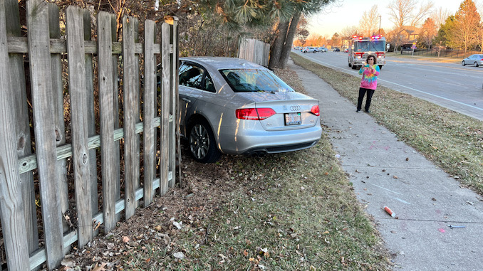 Silver Audi through the backyard fence at crash scene at Buffalo Grove Road and Deerfield Parkway in Buffalo Grove Sunday afternoon December 4, 2022