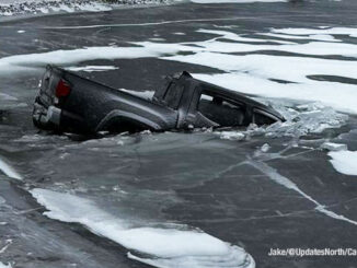 A Chevy pickup truck broke through the ice on the surface of a pond when the driver lost control of the truck in wintry weather at Mount Prospect Road and Howard Street in Des Plaines (PHOTO CREDIT: Jake/@UpdatesNorth/CapturedNews)
