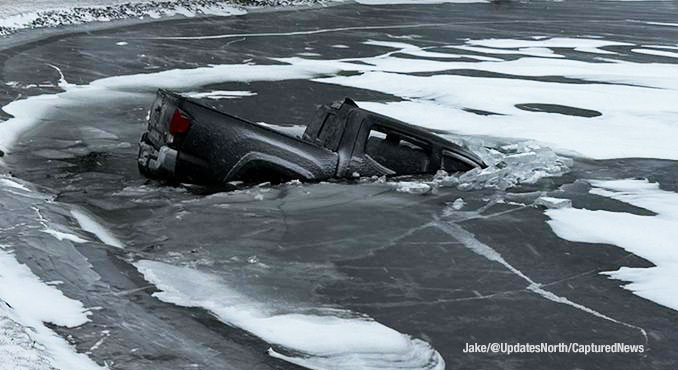 A Chevy pickup truck broke through the ice on the surface of a pond when the driver lost control of the truck in wintry weather at Mount Prospect Road and Howard Street in Des Plaines (PHOTO CREDIT: Jake/@UpdatesNorth/CapturedNews)