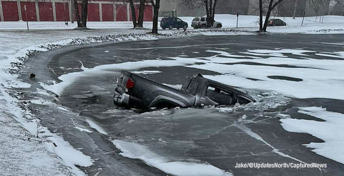 A Chevy pickup truck broke through the ice on the surface of a pond when the driver lost control of the truck in wintry weather at Mount Prospect Road and Howard Street in Des Plaines (PHOTO CREDIT: Jake/@UpdatesNorth/CapturedNews)