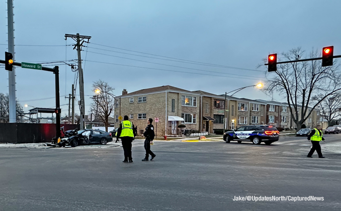 Crashed dark sedan where a person was trapped in the vehicle in a crash at Milwaukee Avenue and Howard Street in Niles (SOURCE: Jake/@UpdatesNorth/CapturedNews).