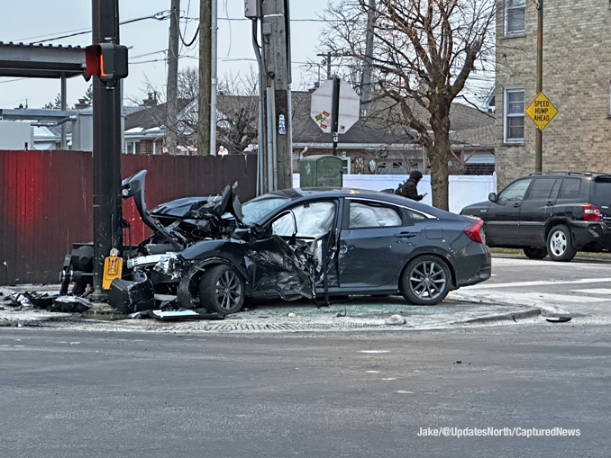 Crashed dark sedan where a person was trapped in the vehicle in a crash at Milwaukee Avenue and Howard Street in Niles (SOURCE: Jake/@UpdatesNorth/CapturedNews)