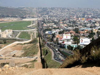 A small fence separates densely populated Tijuana, Mexico, right, from the United States in the Border Patrol's San Diego Sector (SOURCE: US government photo in public domain)