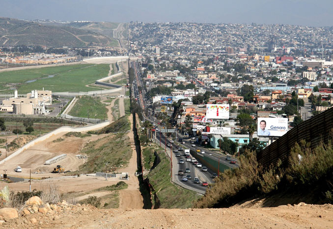 A small fence separates densely populated Tijuana, Mexico, right, from the United States in the Border Patrol's San Diego Sector (SOURCE: US government photo in public domain)