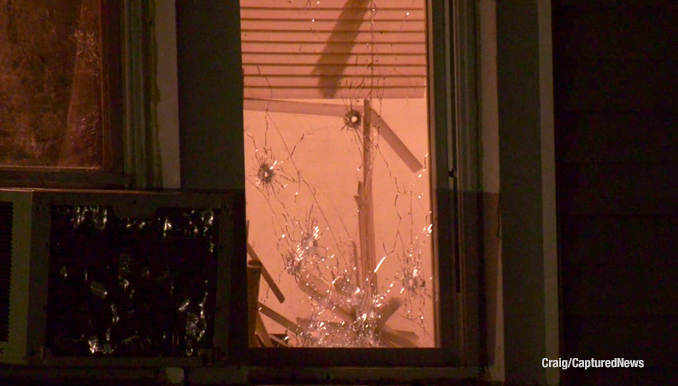 Bullet holes in a window at a house in Waukegan after two people were shot Monday night January 23, 2023 (SOURCE: Craig/CapturedNews)