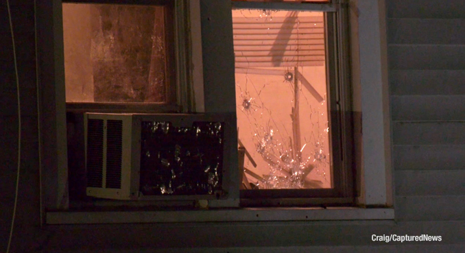 Bullet holes in a window at a house in Waukegan after two people were shot Monday night January 23, 2023 (SOURCE: Craig/CapturedNews)