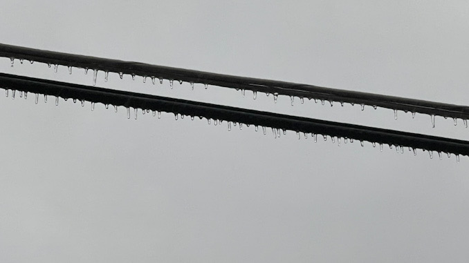 Ice coating on power lines over a parkway about 4:15 p.m. Wednesday, February 22, 2023
