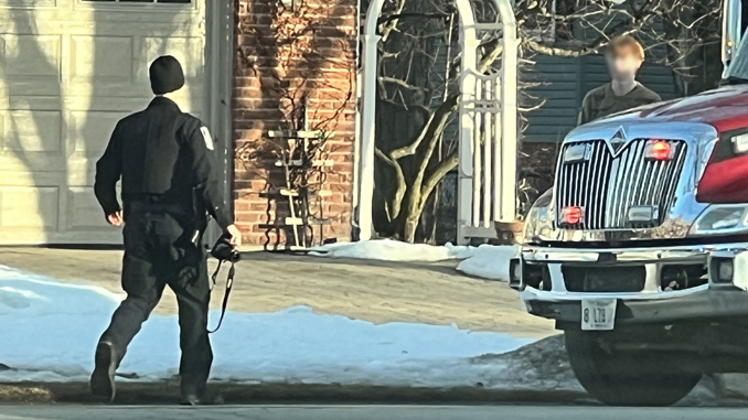A police officer brings a camera apparently to photograph injury evidence on a teen being assessed by paramedics in the back of an ambulance on Dryden Avenue near Jules Street in Arlington Heights Monday, February 6, 2023