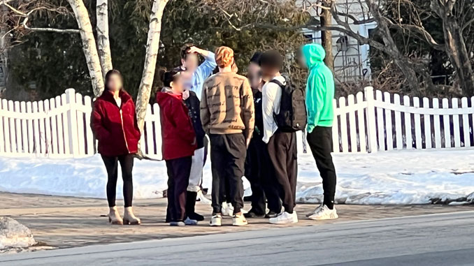 Parents and teens discuss a fight case with a police officer on Dryden Avenue near Jules Street in Arlington Heights Monday, February 6, 2023