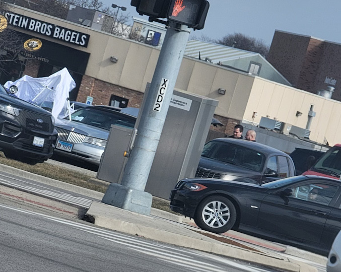 Palatine police investigated the scene where a homeless person was found dead in a silver Lincoln Town Car Thursday afternoon, March 23, 2023.