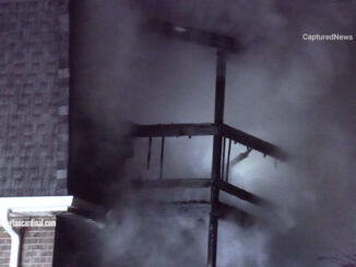 Smoke fills the air at a third floor balcony at the back of an apartment building on the west side of the building Sunday, March 19, 2023 (CARDINAL NEWS)