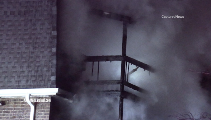 Smoke fills the air at a third floor balcony at the back of an apartment building on the west side of the building Sunday, March 19, 2023 (CARDINAL NEWS)