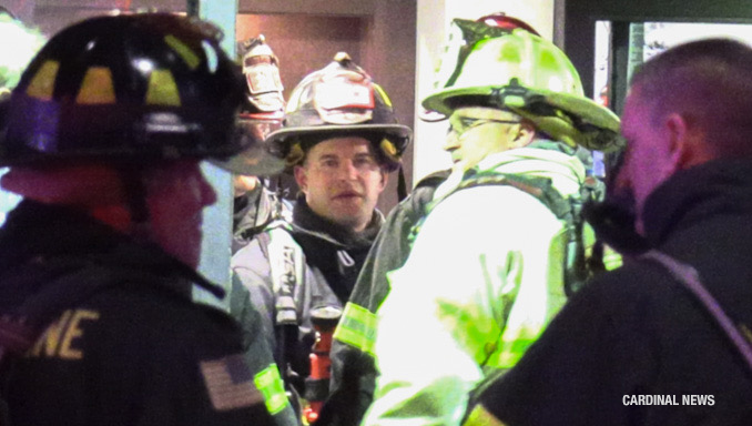 Fighters stand by in the front lobby while other crews worked  on the residential fires to extinguish the fire and evacuate residents.