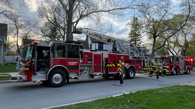 Tower 1 and Engine 2 at the front of a house with a small fire inside
