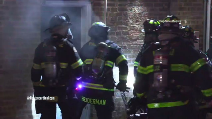 Firefighters forcing entry at the back door of a business on Northwest Highway in Palatine on Saturday, April 22, 2023 (CARDINAL NEWS)