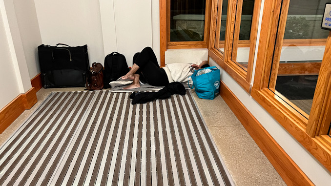 Two people camped out and sleeping in the Arlington Heights police station vestibule overnight in early May, 2023