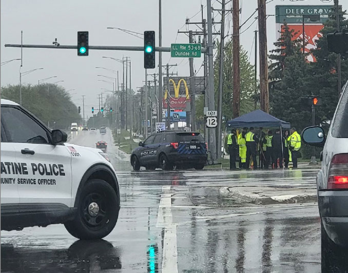 MCAT-STAR crash investigators on scene with Palatine police officer at a vehicle vs pole crash at Rand Road and Dundee Road in Palatine on Monday, May 8, 2023
