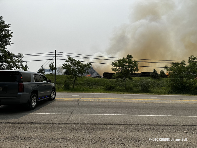 Firefighters working to extinguish burning mulch at Route 120 and Wilson Road in Grant Township near Round Lake (PHOTO CREDIT: Jimmy Bolf).