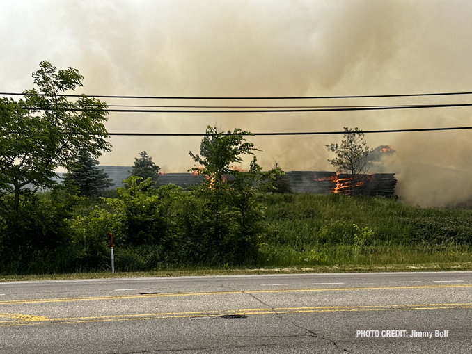 Firefighters working to extinguish burning mulch at Route 120 and Wilson Road in Grant Township near Round Lake (PHOTO CREDIT: Jimmy Bolf).