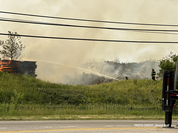 Firefighters working to extinguish burning mulch at Route 120 and Wilson Road in Grant Township near Round Lake (PHOTO CREDIT: Jimmy Bolf).