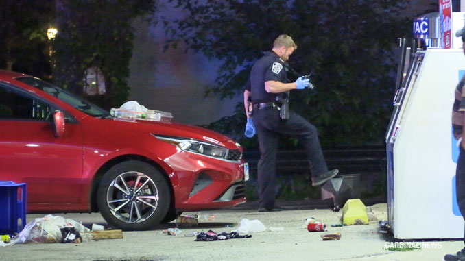 Arlington Heights police officer gathering photographic evidence at the scene of a fight with injuries at the Mobil gas station 102 West Northwest Highway in Arlington Heights, Thursday, July 6, 2023 (CARDINAL NEWS)