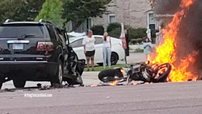 A motorcycle burns after a crash with a GMC SUV just before police arrived on Thursday, July 13, 2023 about 7:12 p.m. (VIDEO IMAGE CREDIT: George Young)