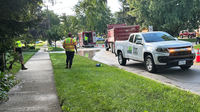 USIC crew on scene while Arlington Heights Public Works Department crews repair a water main break on westbound Euclid Avenue between Dryden Avenue and Arlington Heights Road Saturday morning, July 29, 2023