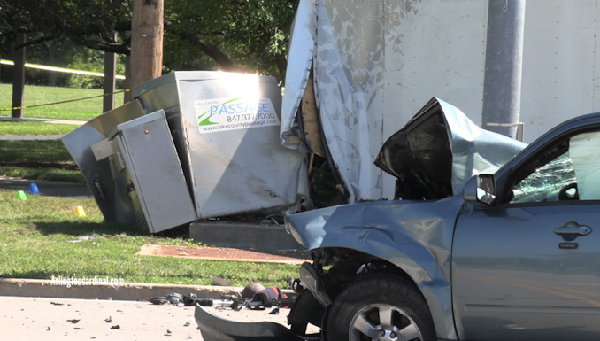 Ford Escape in the foreground and the traffic signal box and the large trailer in the background after a fatal crash in Grayslake on Saturday, July 29, 2023