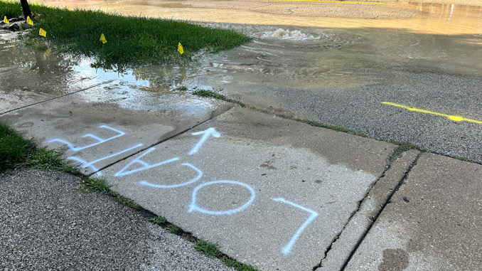 USIC crew location markings on scene while Arlington Heights Public Works Department crews repair a water main break on westbound Euclid Avenue between Dryden Avenue and Arlington Heights Road Saturday morning, July 29, 2023