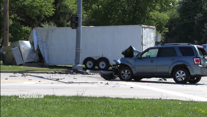 Ford Escape in the foreground and the traffic signal box and the large trailer in the background after a fatal crash in Grayslake on Saturday, July 29, 2023