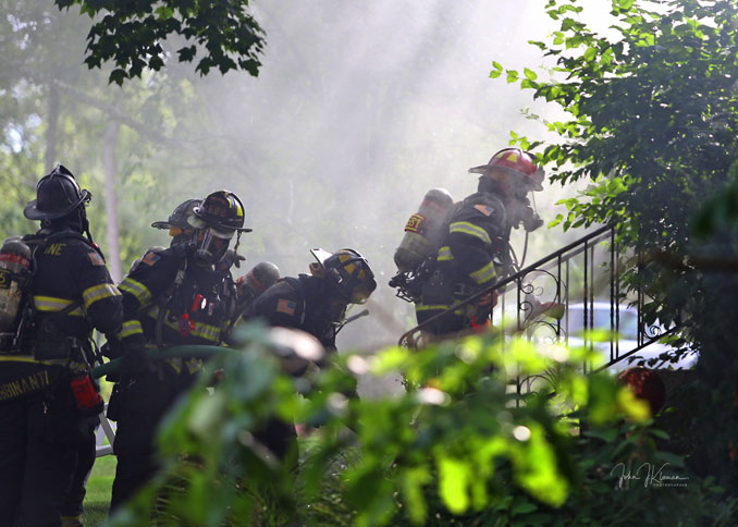 Firefighters advance hose line into house attached fully-involved garage fire on Hill Road in Palatine on Wednesday, July 19, 2023 (PHOTO CREDIT: John J. Kleeman)