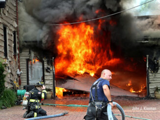 Firefighters advancing hose lines at a garage fire on Hill Road in Palatine on Wednesday evening, July 19, 2023 (PHOTO CREDIT: John J. Kleeman)