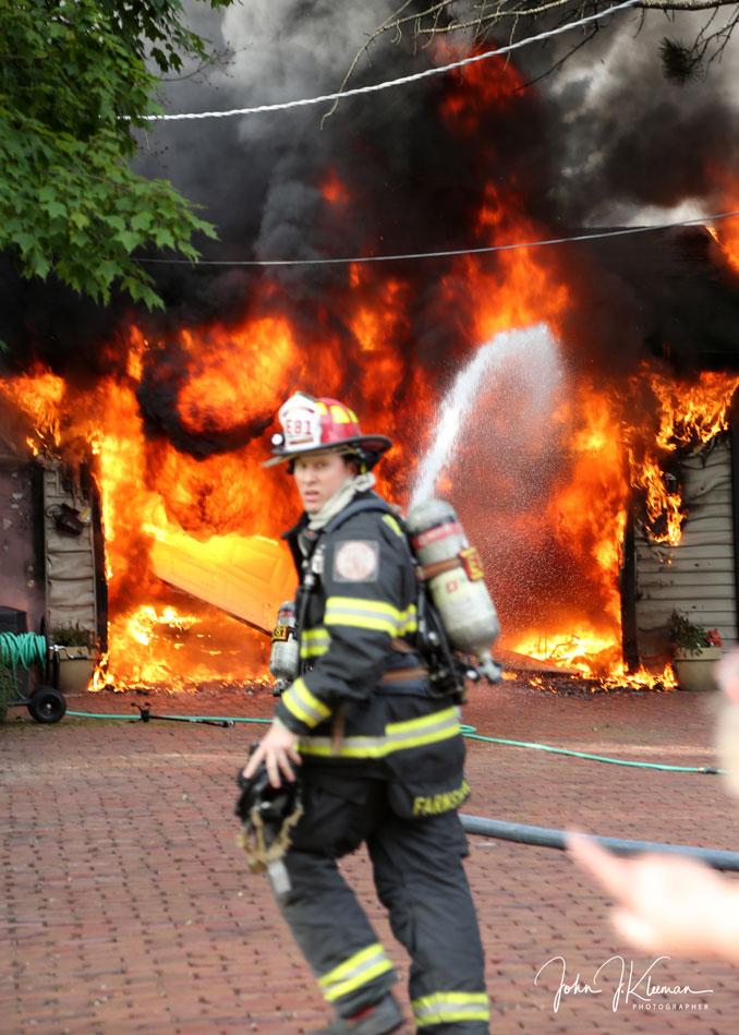 Fire lieutenant surveying fire scene at a garage fire on Hill Road in Palatine on Wednesday evening, July 19, 2023 (PHOTO CREDIT: John J. Kleeman)