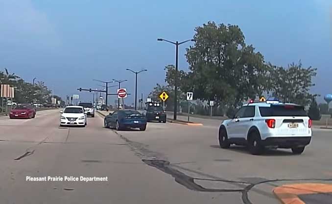 Police pursuit of blue Chevy Camaro in Wisconsin after it was carjacked on Caribou Crossing in Northbrook, Illinois (SOURCE: Pleasant Prairie Police Department dashcam)