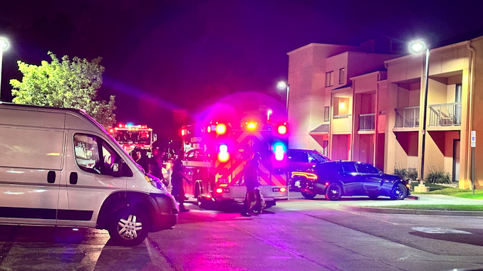 Paramedics return equipment to the ambulance after assessing a patient found unresponsive in a hotel parking lot in Arlington Heights Thursday, August, 10, 2023.