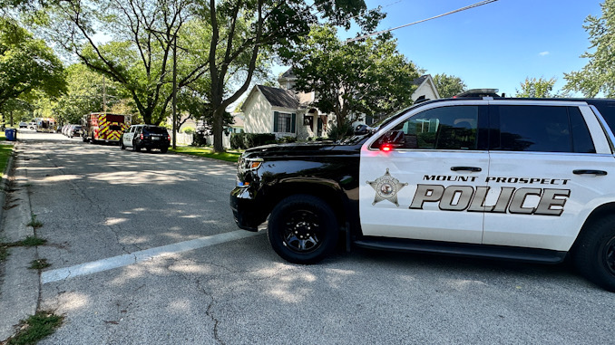 Mount Prospect police block Evergreen Avenue while Mount Prospect Fire Department paramedics treat an injured bicyclist who crashed into a parked car on Wednesday afternoon, August 16, 2023 (CARDINAL NEWS)