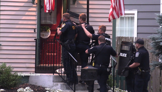 Arlington Heights police officers at the front door with protective body shields and rifles, preparing to enter the house where shots were heard on Saturday, August 5, 2023.