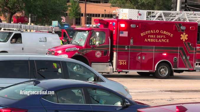 Buffalo Grove Fire Department ambulance with teen boy inside parked next to the white van that he was underneath after he was run over on Monday evening, July 31, 2023 (CARDINAL NEWS)