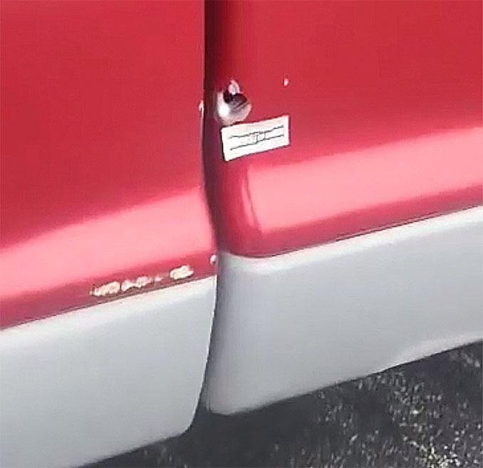 Bullet hole behind the passenger door of a red pickup truck after a shooting at the Crave bar parking lot July 1, 2023 (Provided photo with source withheld)
