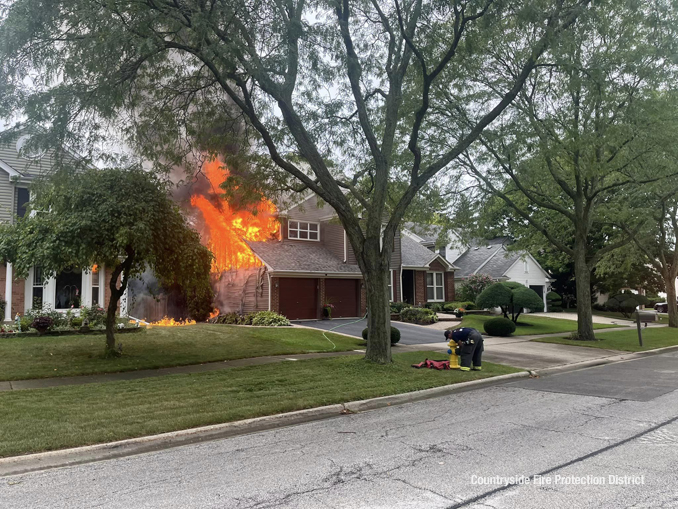 A firefighter connects a hydrant for water supply while preparing for fire attack at a house fire on Dearborn Lane in Vernon Hills on Monday, September 11, 2023 (SOURCE: Countryside Fire Protection District)