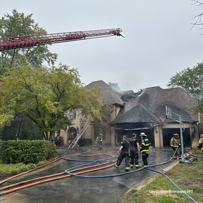Aerial ladder over the area where fire was showing through the roof at a house on Rose Terrace in Riverwoods on Monday morning, September 11, 2023 (SOURCE: Lincolnshire-Riverwoods Fire Protection District)
