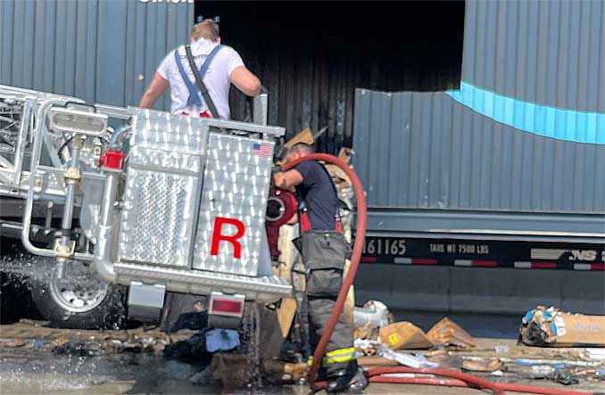 Firefighters soaking contents of Amazon semi-trailer truck after fire on the shoulder of I-90 on Wednesday, September 6, 2023