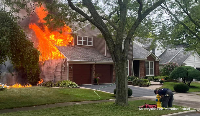 A firefighter connects a hydrant for water supply while preparing for fire attack at a house fire on Dearborn Lane in Vernon Hills on Monday, September 11, 2023 (SOURCE: Countryside Fire Protection District)