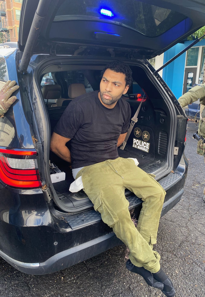 Rene Chandler arrested and sitting in the back of an SUV in Oregon (SOURCE: Cook County Sheriff's Office)