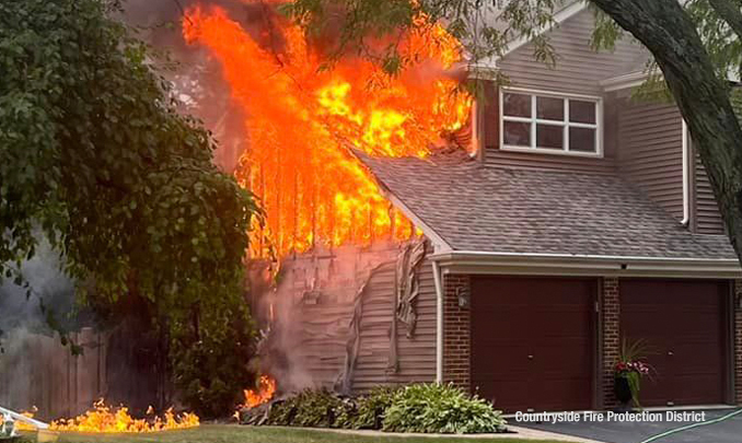 Fire from siding and roof of an attached garage at a house fire on Dearborn Lane in Vernon Hills on Monday, September 11, 2023 (SOURCE: Countryside Fire Protection District)