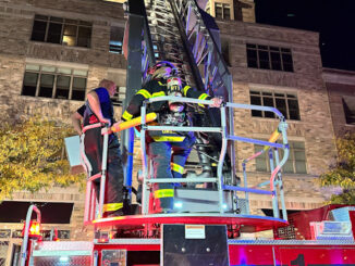 Firefighters at the aerial ladder of Tower 1 on Dunton Avenue.
