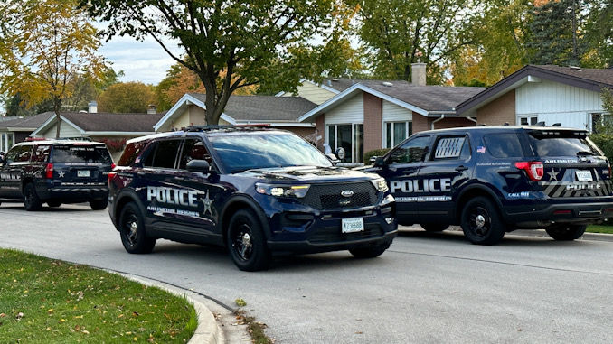 Arlington Heights police officers meeting in the neighborhood S. Central Rd. in west of Arlington Heights Road after a wanted suspect that was possibly armed was in the neighborhood Tuesday, October 24, 2023.