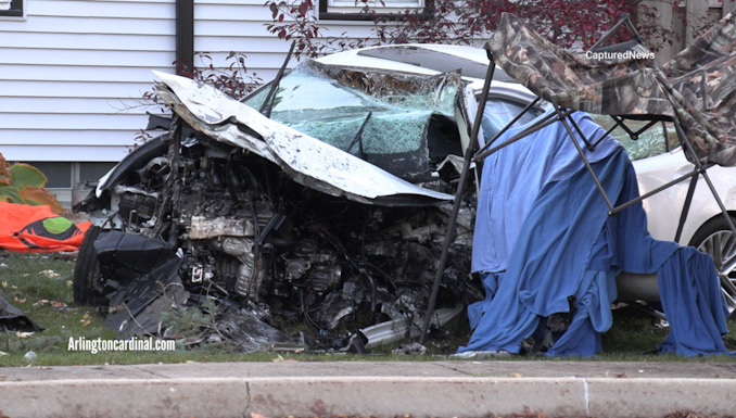 A Lexus sedan wrecked after the driver was killed while involved in a single-vehicle crash with a wood streetlight pole and a house on the west side of Quentin Road in Palatine, Monday, October 30, 2023